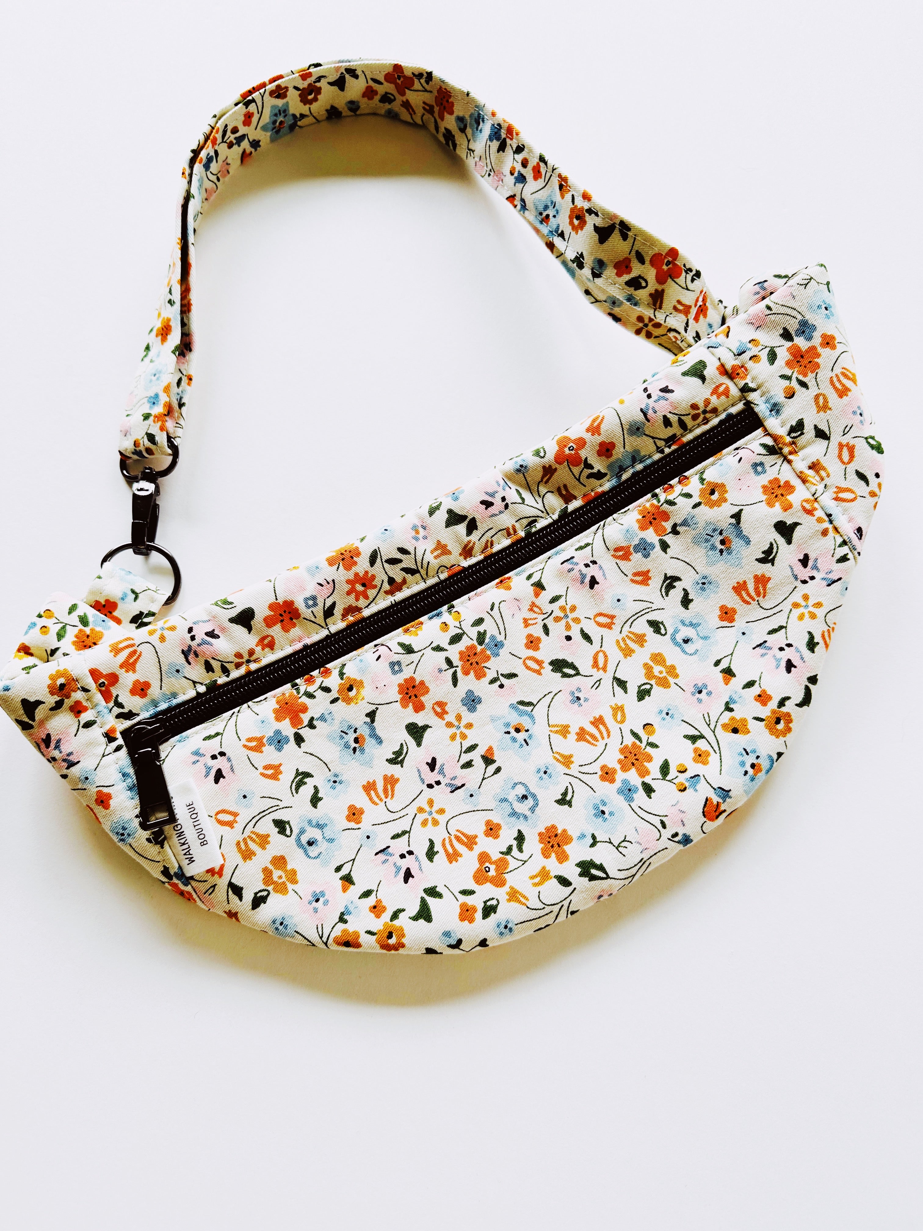 White fabric with little flowers fanny pack with black metals